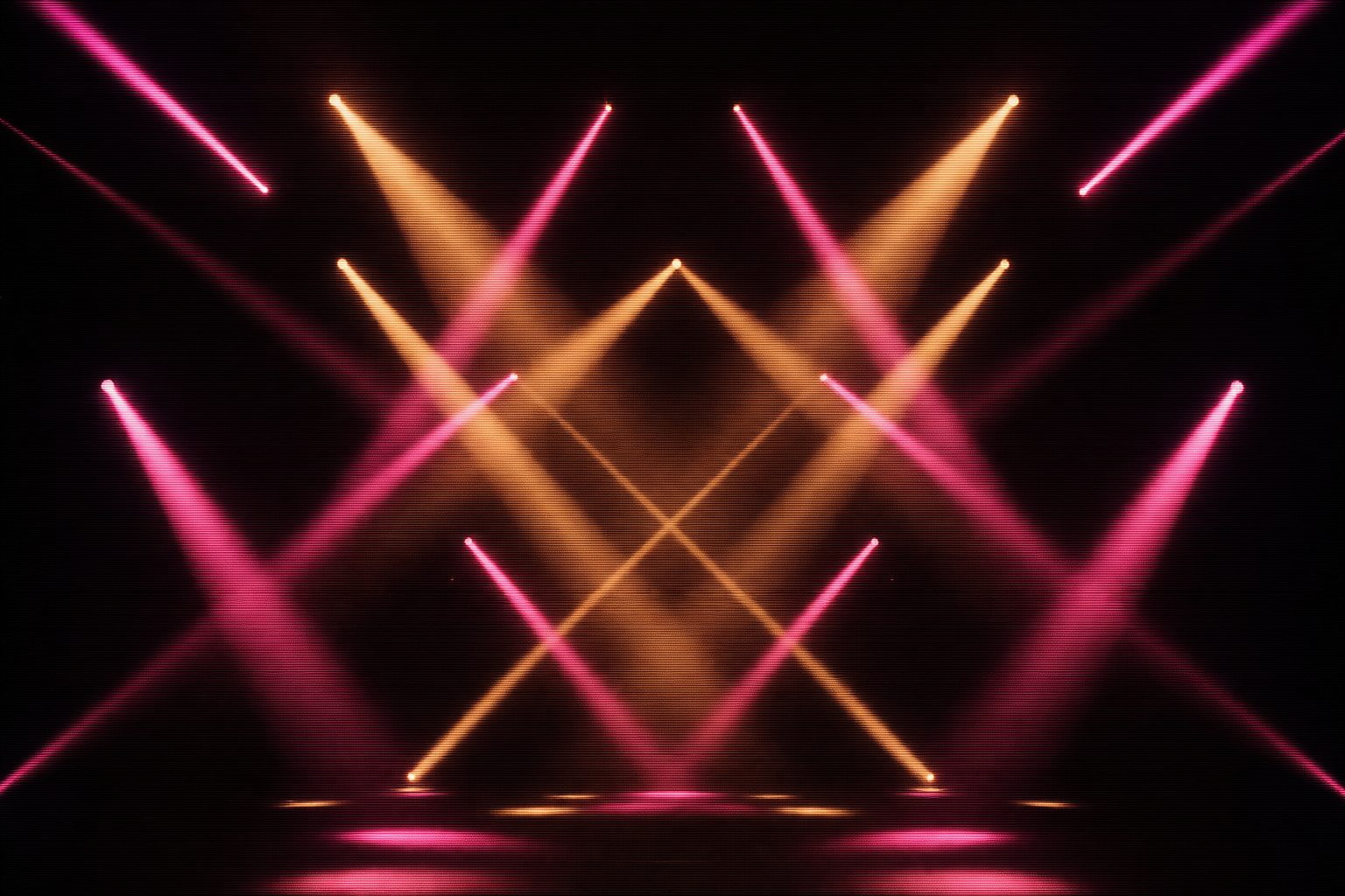 Crossing beams of magenta and amber light forming a lattice in mid-air above an empty stage deck.